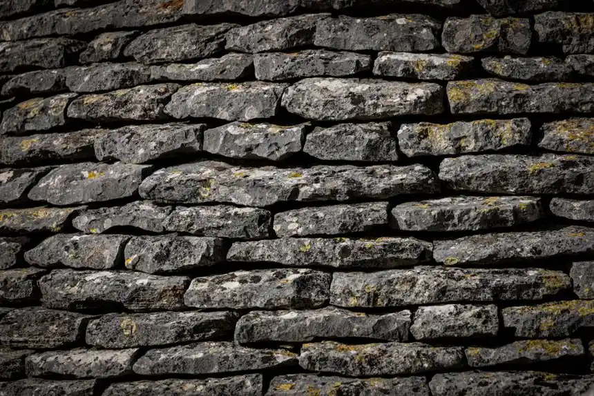 Close-up view of a textured stone wall with stacked rocks.